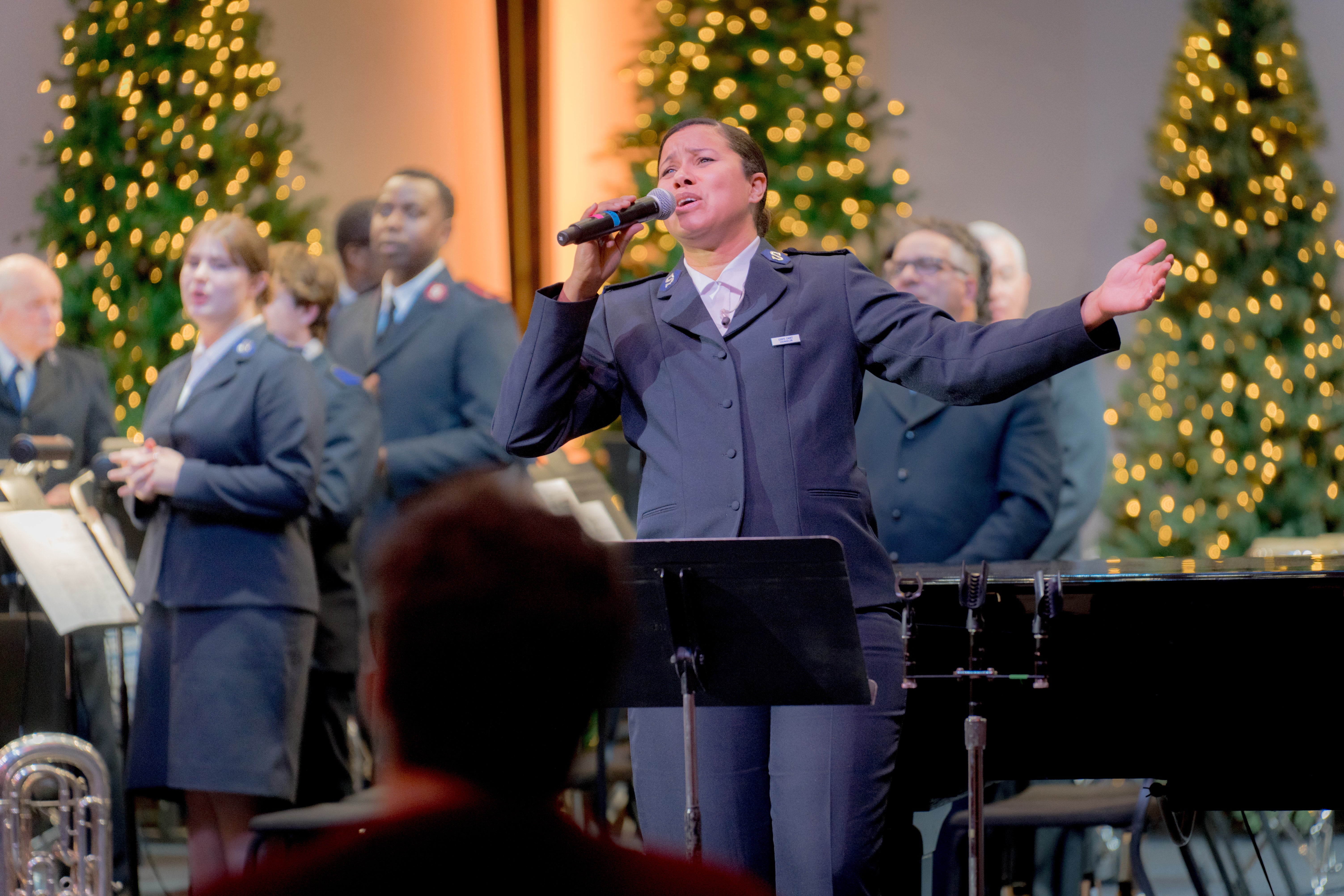 A singer leads the Christmas concert with joyful energy