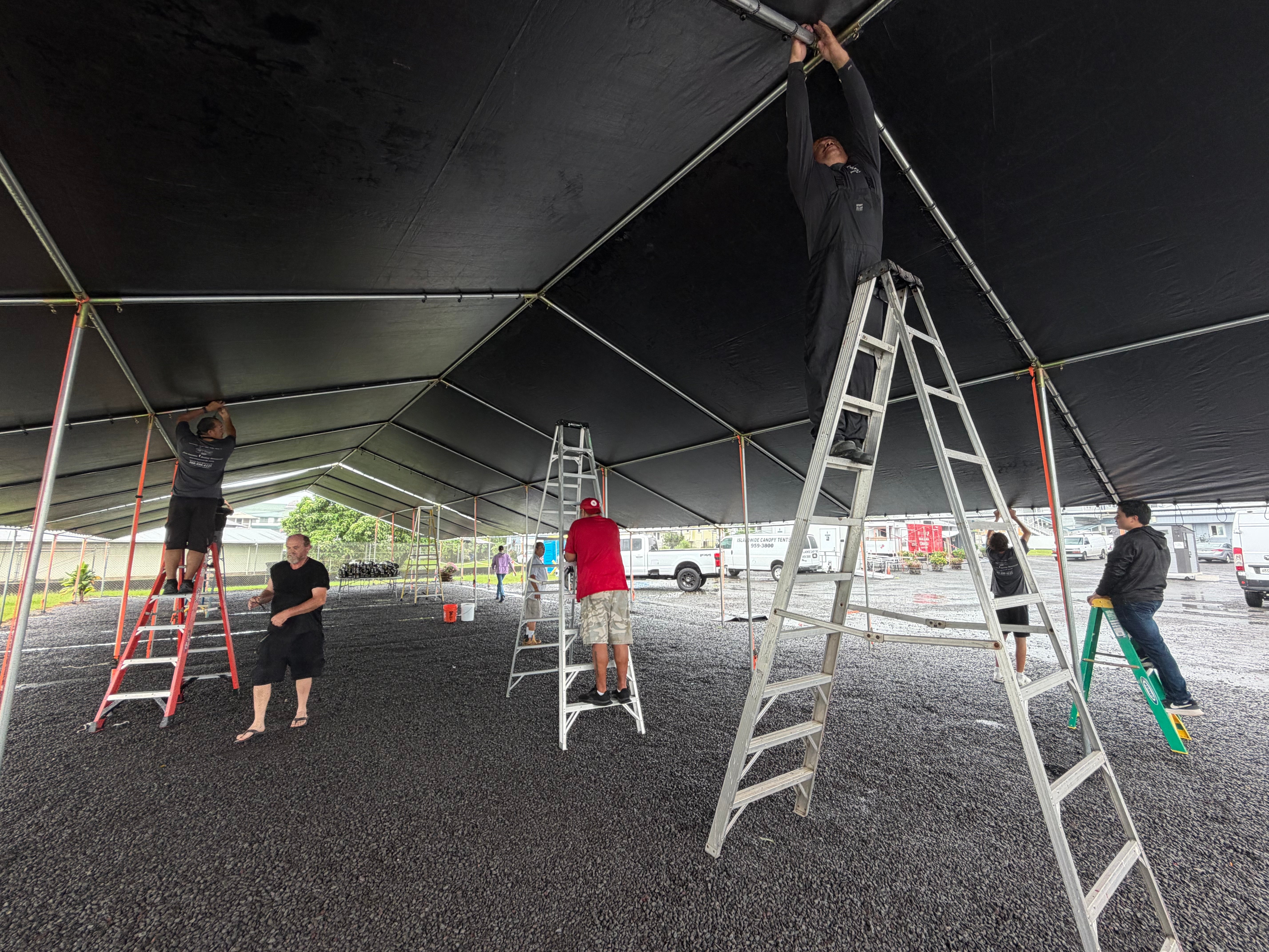Volunteers reassembling the Overnight Safe Space shelter at Hilo Corps