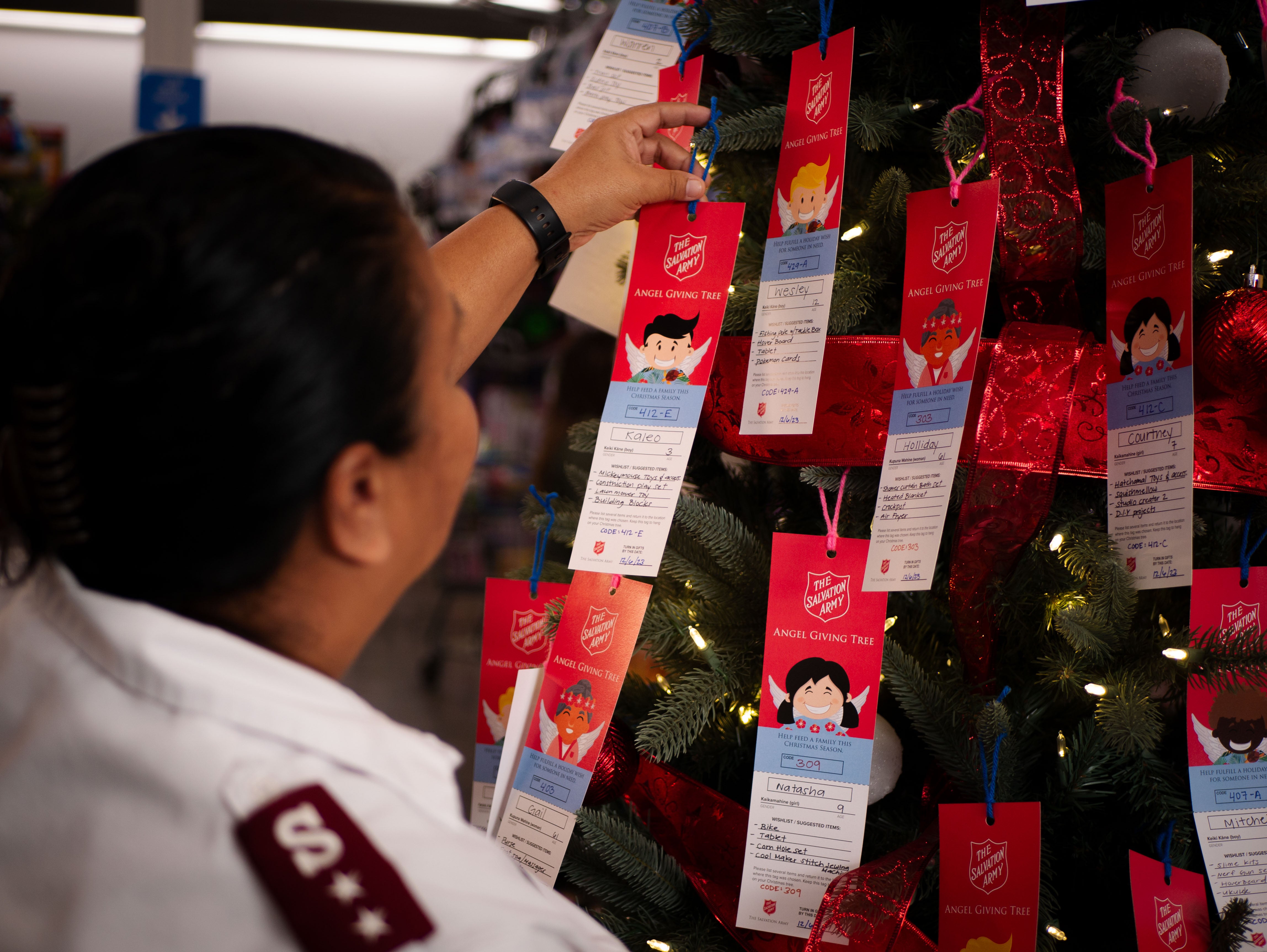 A donor selecting an Angel Tag from an Angel Tree