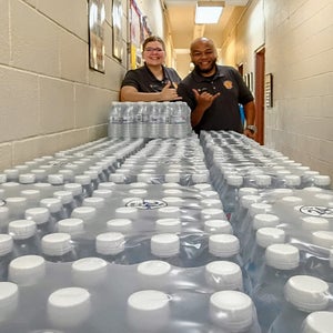 Salvation Army cadets prepare bottled water for Typhoon Bavi distribution
