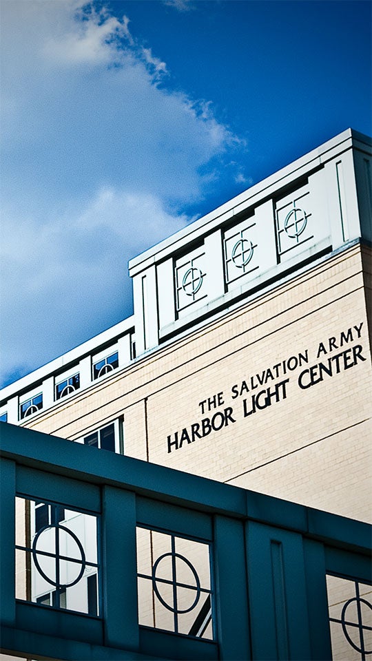 The image shows a building with the text 'The Salvation Army Harbor Light Center' on its facade.