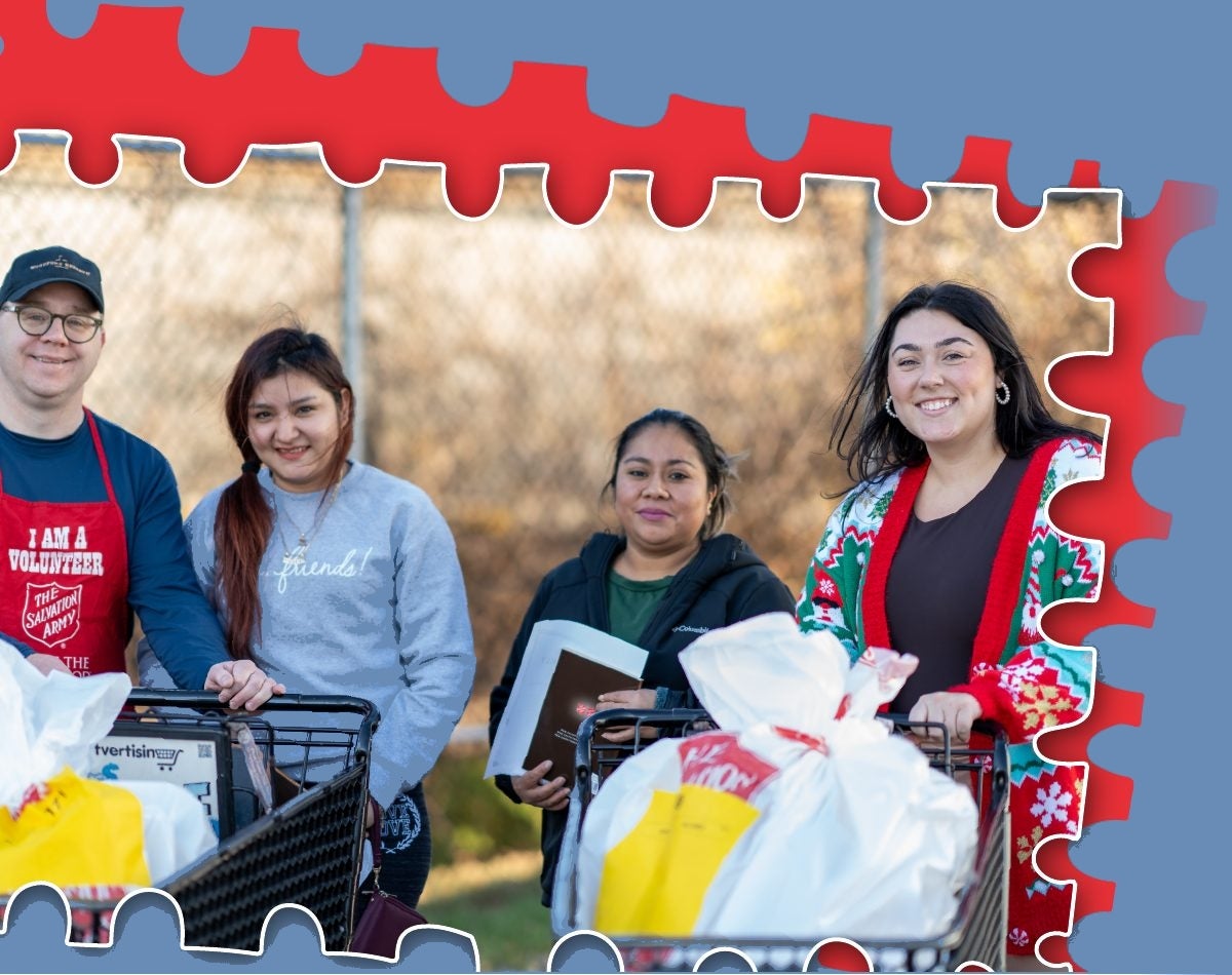Smiling volunteers with carts full of Angel Tree gifts